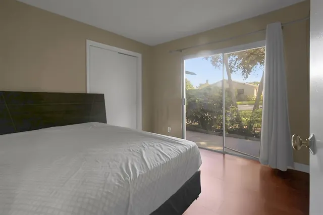 a bedroom with a bed and a large window