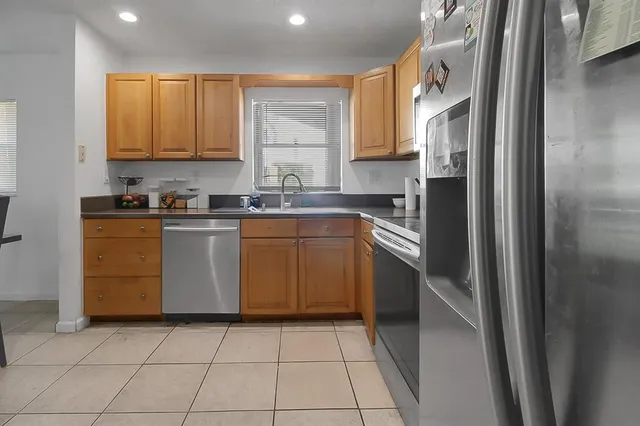 a kitchen with a stove sink and cabinets