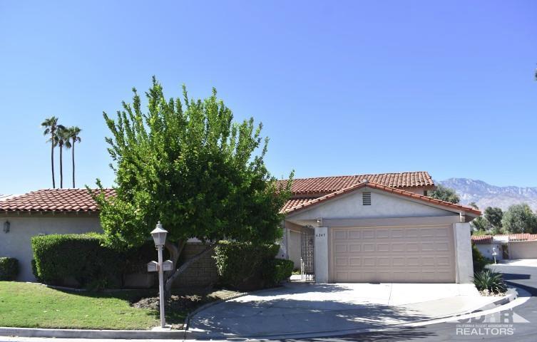 6243 East Driver Road Palm Springs, CA 92264 - Photo 1 of 14 a front view of a house with garden