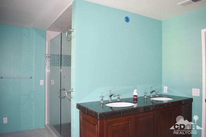 6243 East Driver Road Palm Springs, CA 92264 - Photo 12 of 14 a bathroom with a granite countertop sink and a mirror