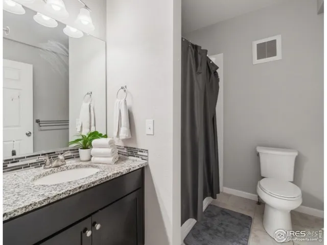 a view of a room that has a bed and a window