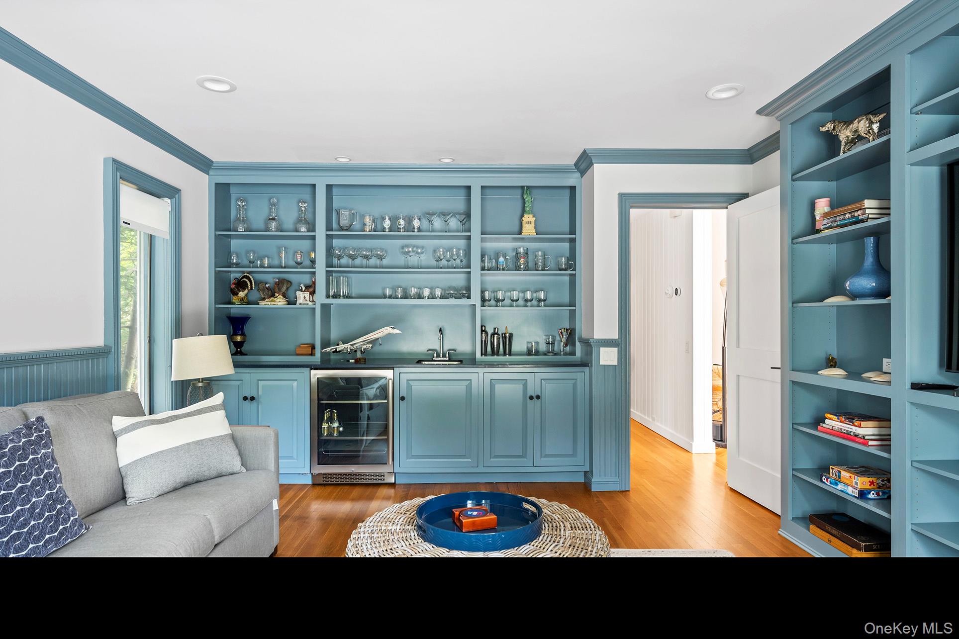 1 Acorn Path Quogue, NY 11959 - Photo 14 of 24 a living room with furniture and a book shelf