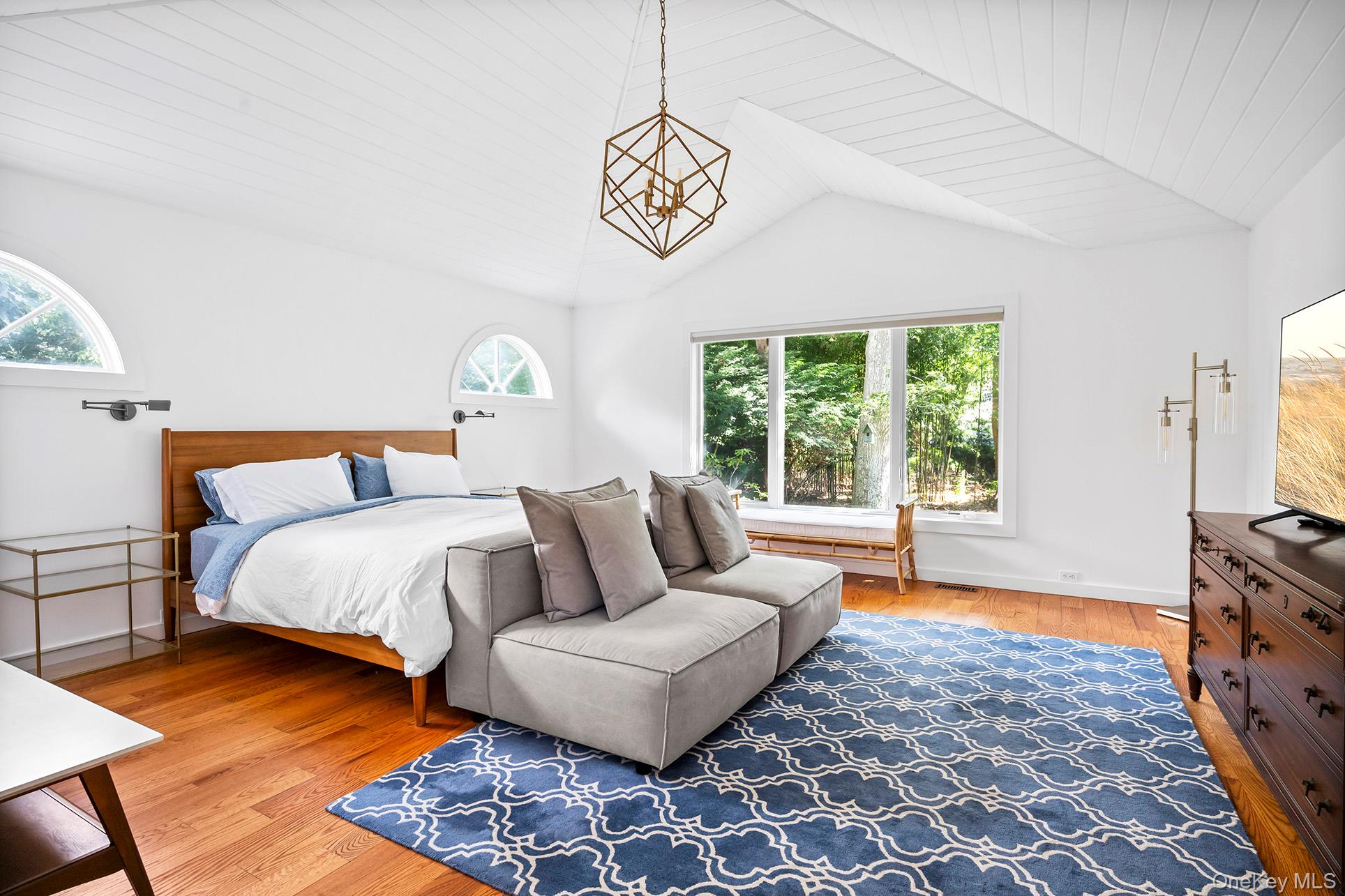 1 Acorn Path Quogue, NY 11959 - Photo 15 of 24 a bedroom with a bed and a couch