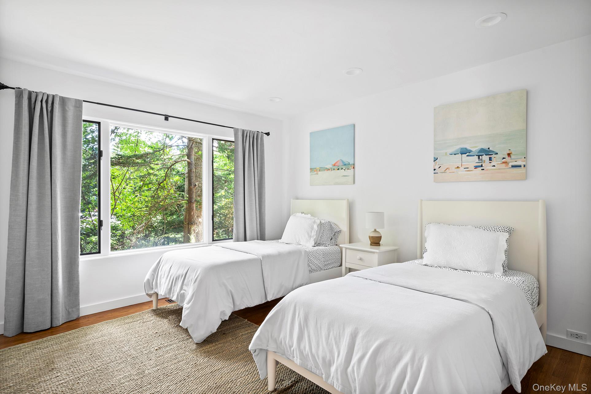 1 Acorn Path Quogue, NY 11959 - Photo 17 of 24 a bedroom with two beds and a large window