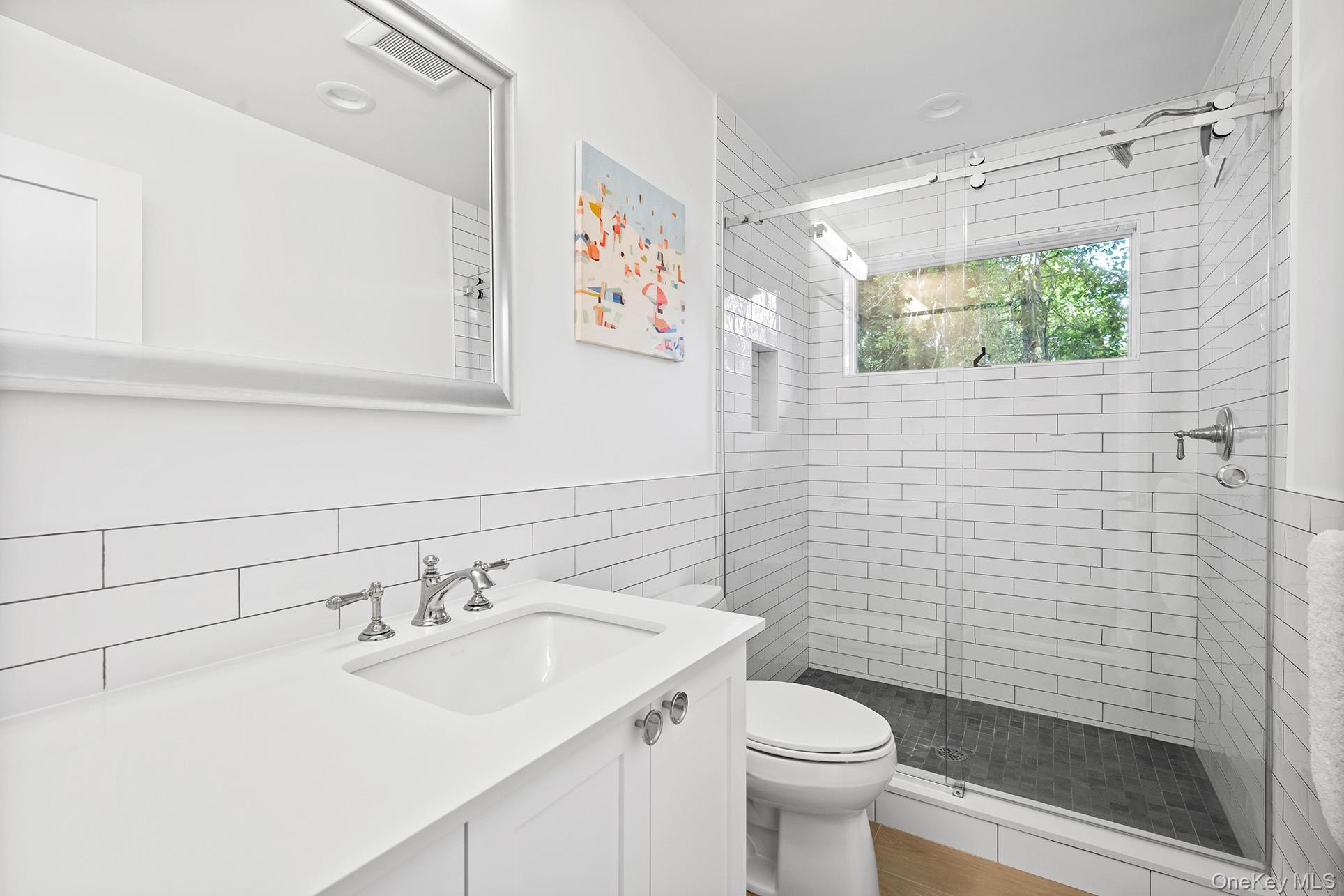 1 Acorn Path Quogue, NY 11959 - Photo 18 of 24 a bathroom with a sink a toilet and shower curtain