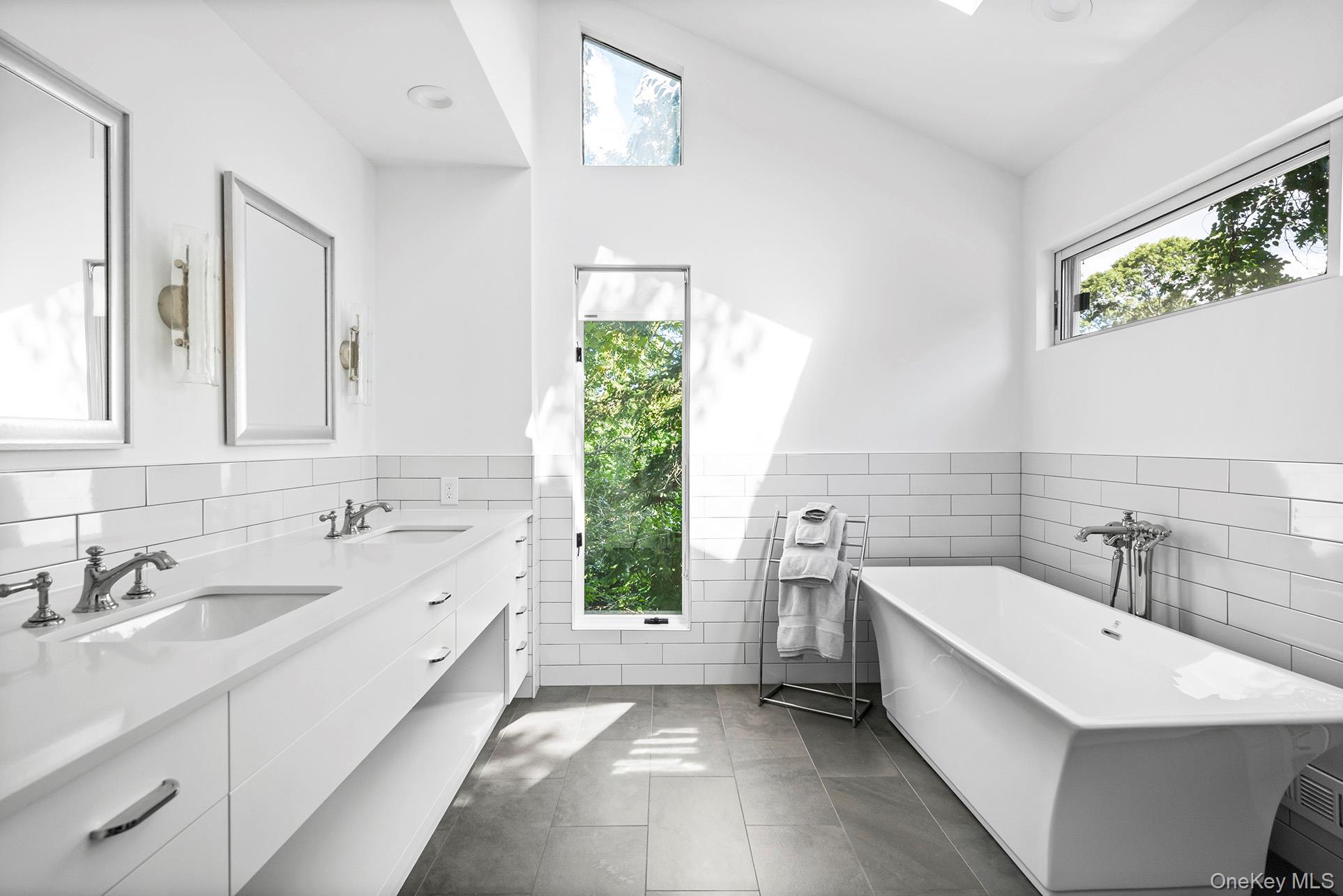 1 Acorn Path Quogue, NY 11959 - Photo 20 of 24 a bathroom with a tub sink and window