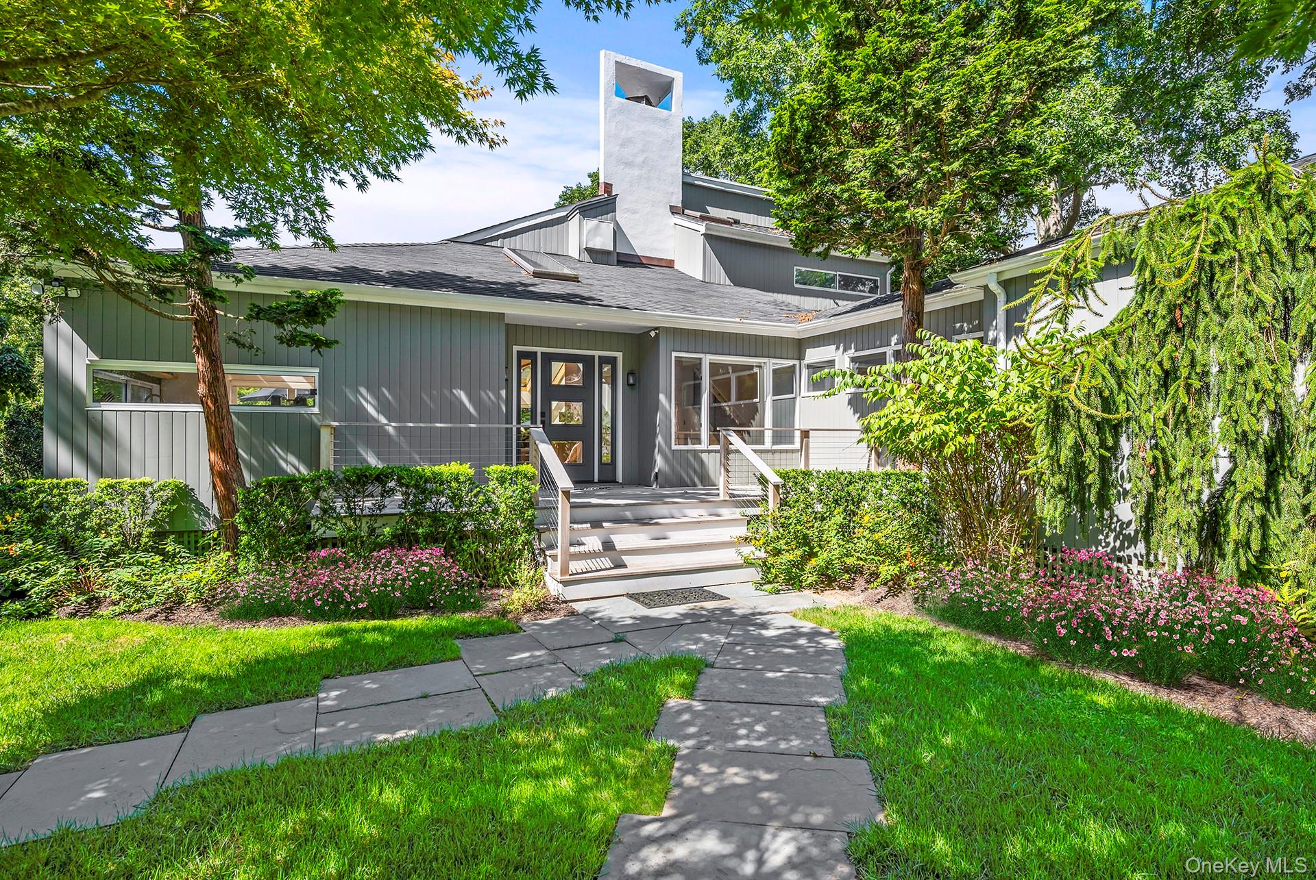 1 Acorn Path Quogue, NY 11959 - Photo 2 of 24 a front view of a house with garden