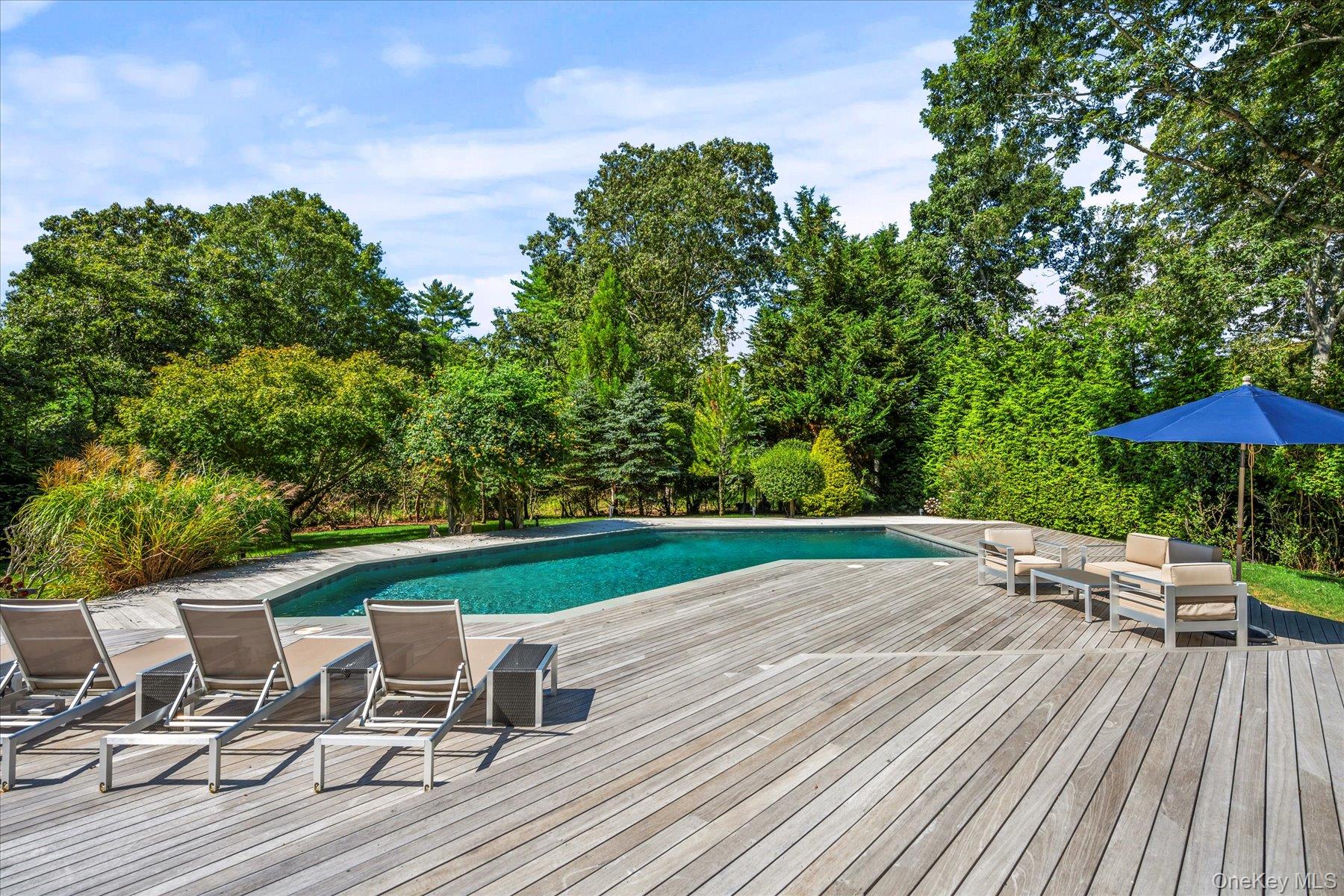 1 Acorn Path Quogue, NY 11959 - Photo 23 of 24 a view of a table and chairs in patio with a fire pit