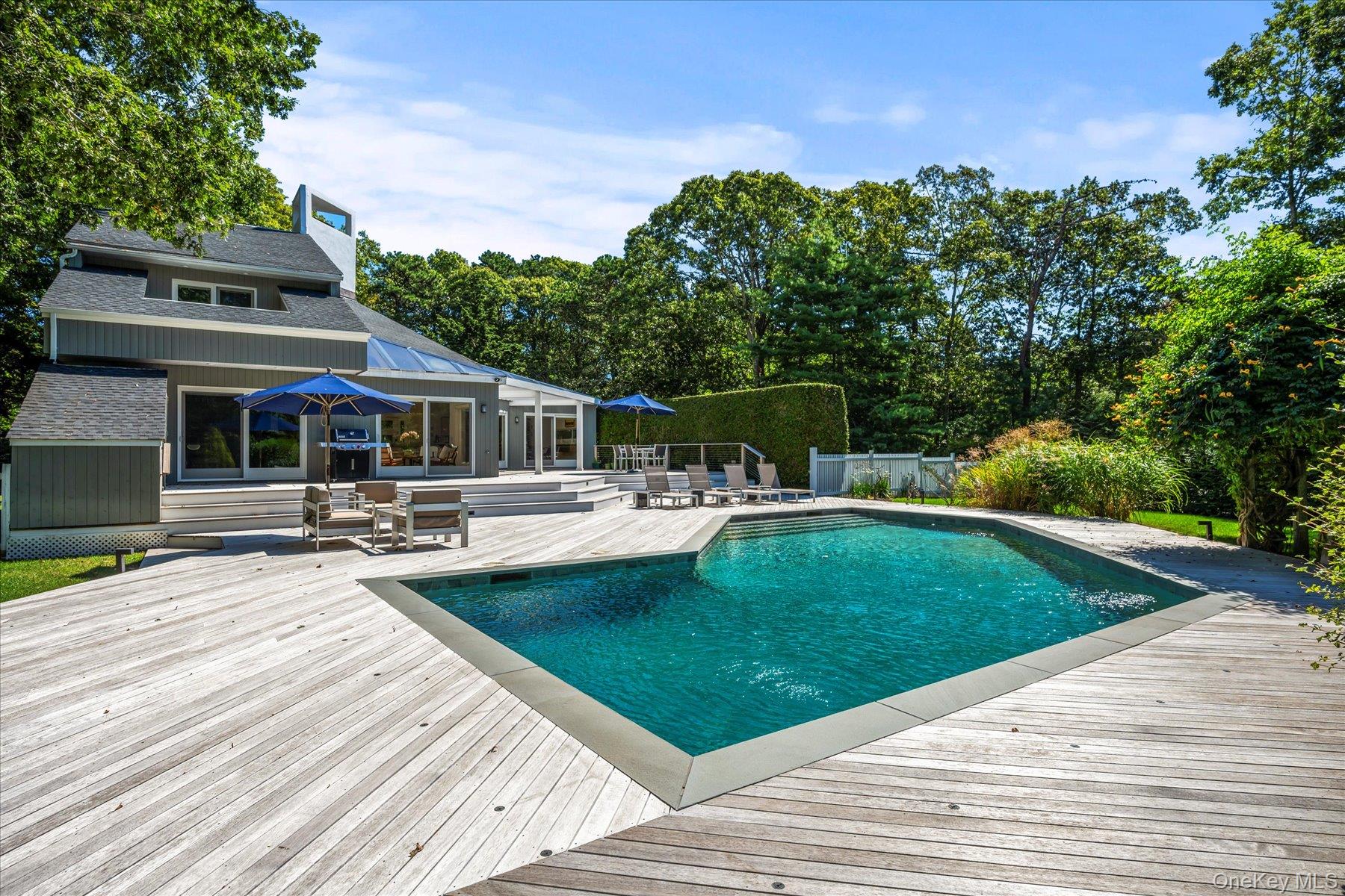 1 Acorn Path Quogue, NY 11959 - Photo 24 of 24 a view of outdoor space yard deck patio and swimming pool