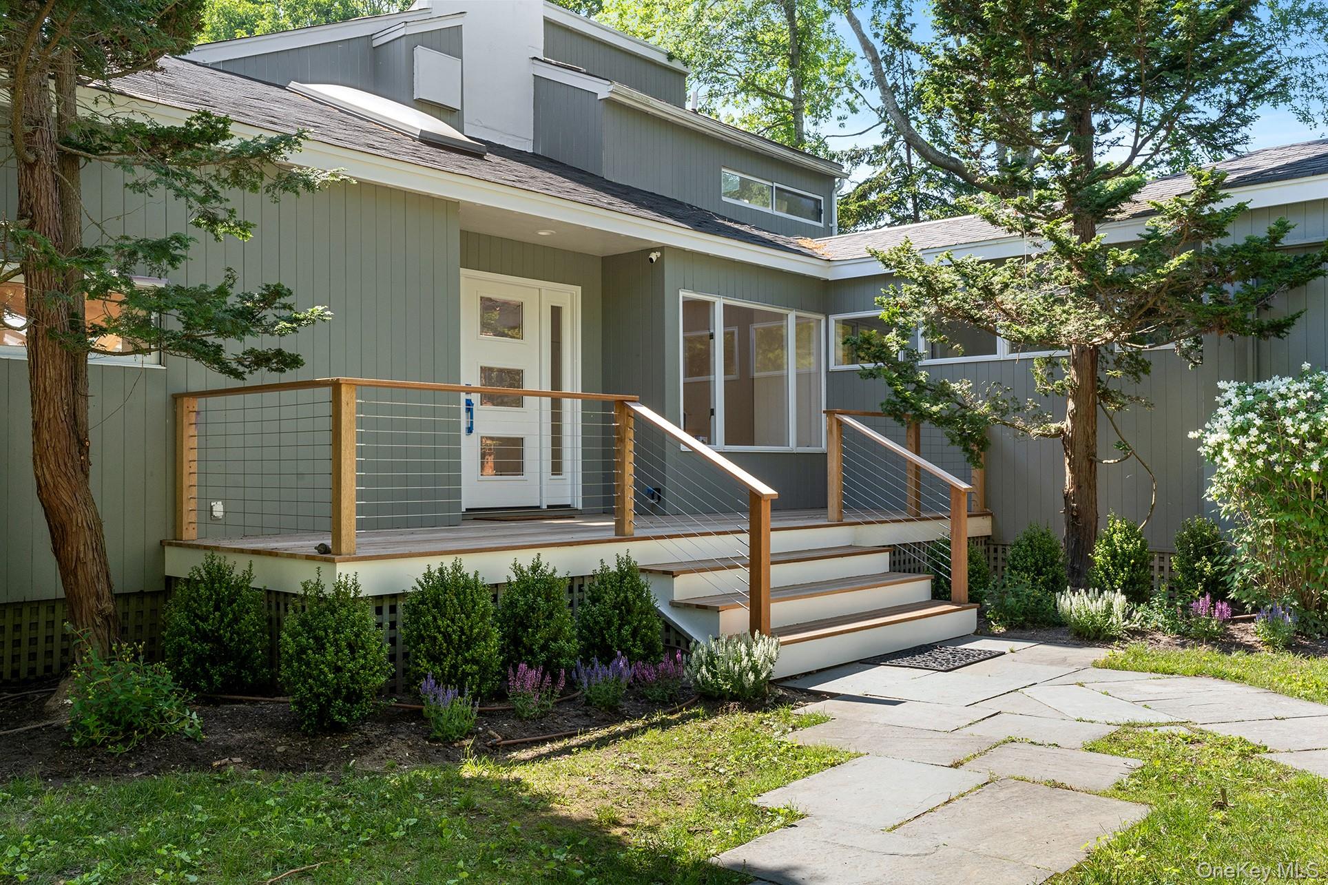 1 Acorn Path Quogue, NY 11959 - Photo 3 of 24 front view of a house with a yard