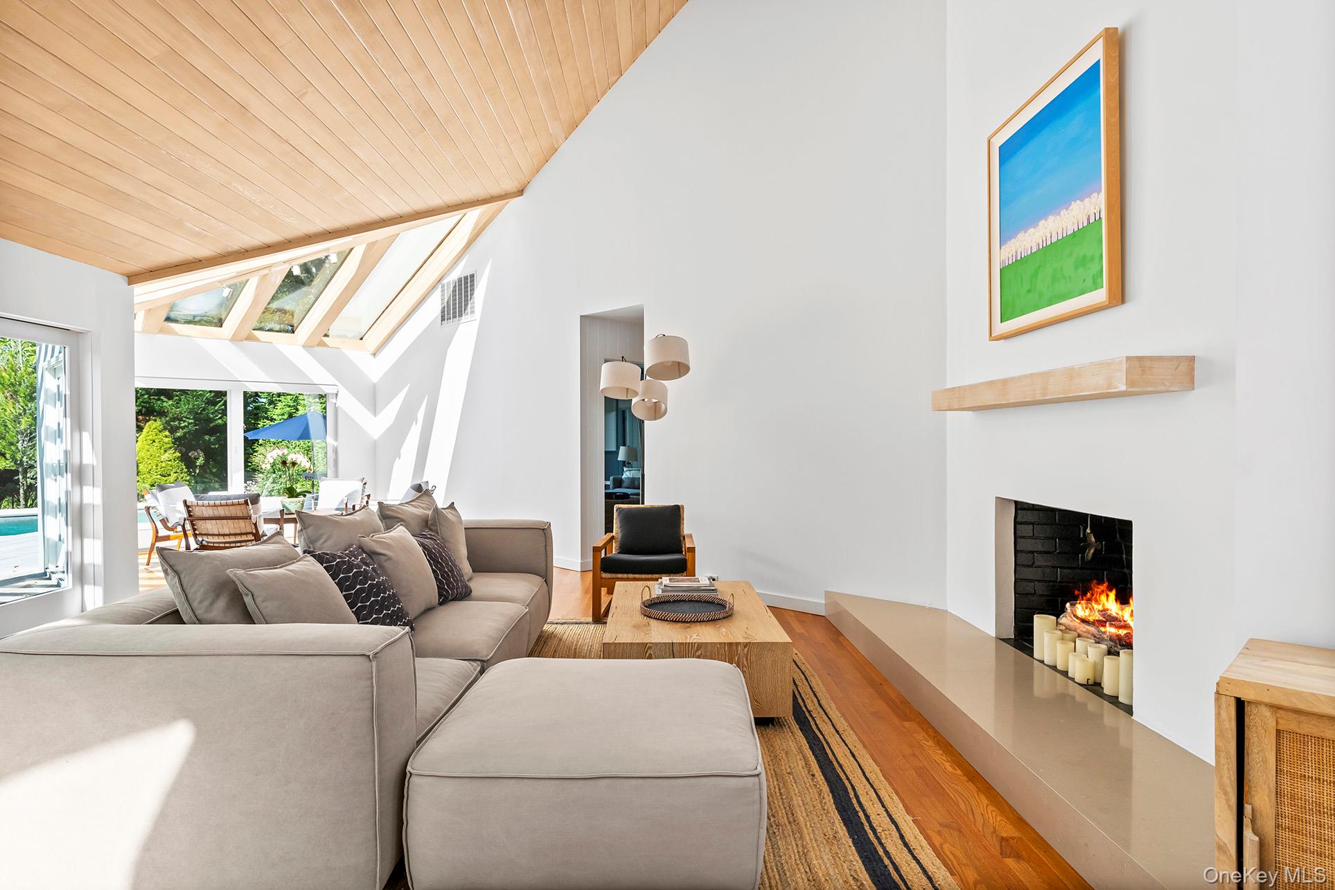 1 Acorn Path Quogue, NY 11959 - Photo 7 of 24 a living room with furniture and a fireplace