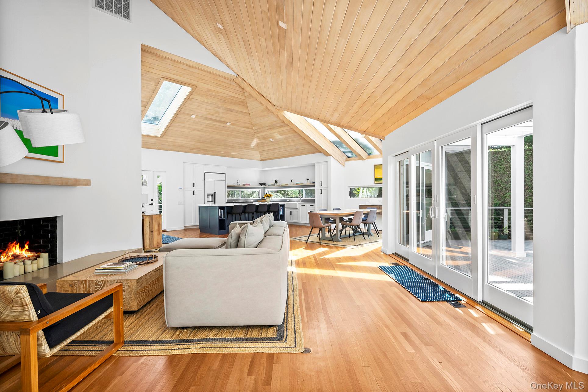 1 Acorn Path Quogue, NY 11959 - Photo 8 of 24 a living room with furniture a fireplace and a table