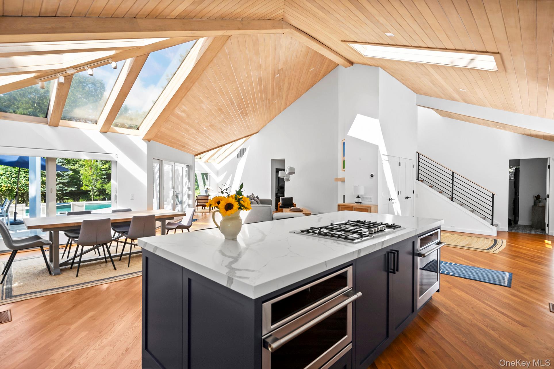 1 Acorn Path Quogue, NY 11959 - Photo 9 of 24 a kitchen with stainless steel appliances a stove a sink dishwasher and a dining table with the view of living room