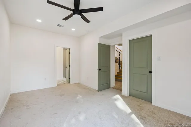a view of a livingroom with a ceiling fan and window