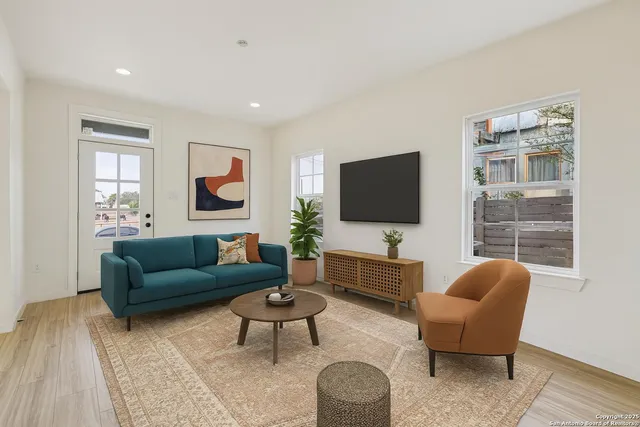 a living room with furniture and a flat screen tv