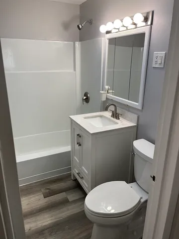 a bathroom with a toilet sink and shower
