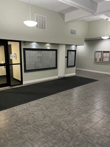 a view of lobby with furniture and wooden floor