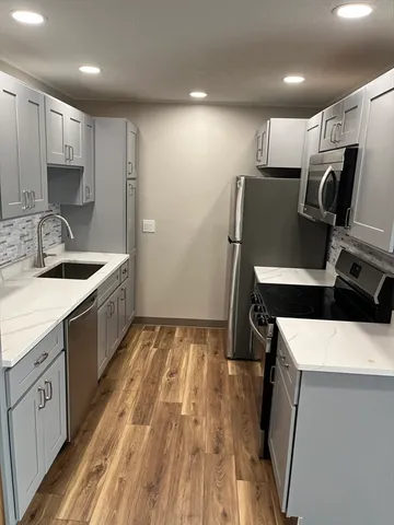 a kitchen that has a sink and a stove in it