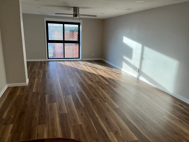 wooden floor in an empty room with a window
