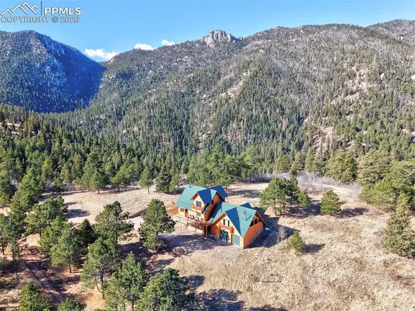 an aerial view of a house with a yard and lake view