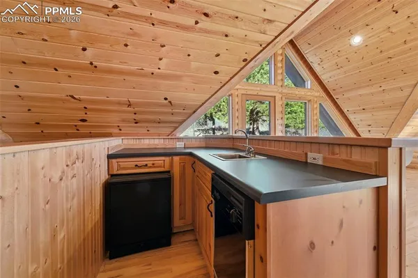 a balcony with view of trees in the background