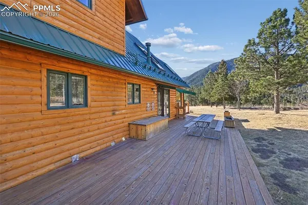 a view of balcony with wooden floor and outdoor seating