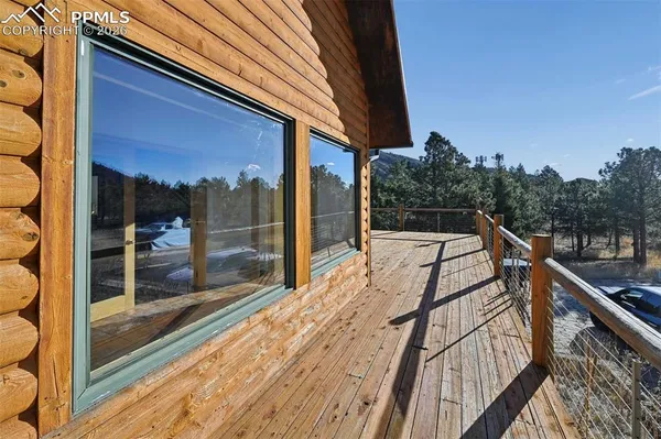 a view of balcony with wooden floor and outdoor seating