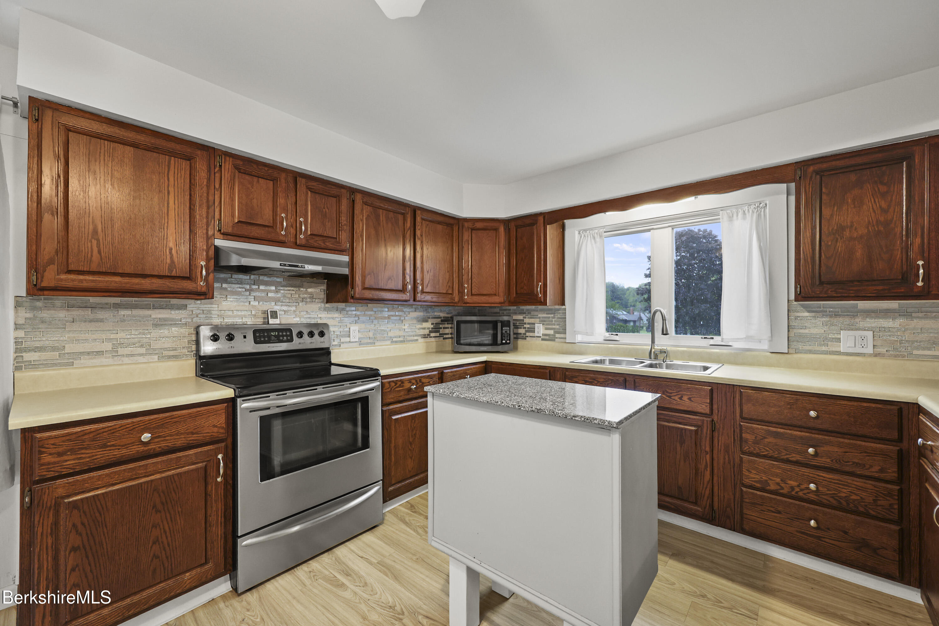 41 Deming Street Dalton, MA 01226 - Photo 12 of 35 a kitchen with wooden cabinets and stainless steel appliances