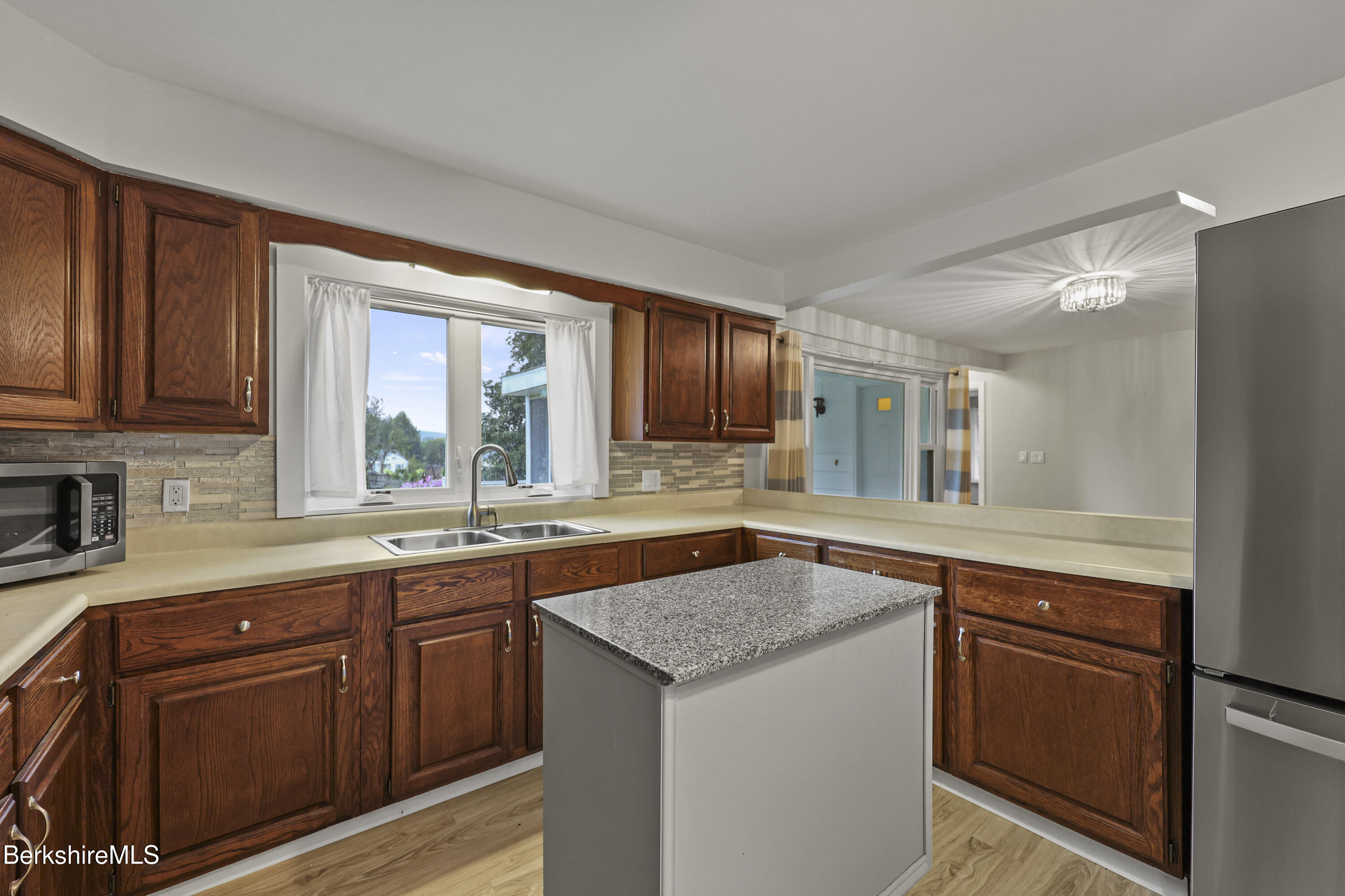 41 Deming Street Dalton, MA 01226 - Photo 13 of 35 a kitchen with a sink and wooden cabinets