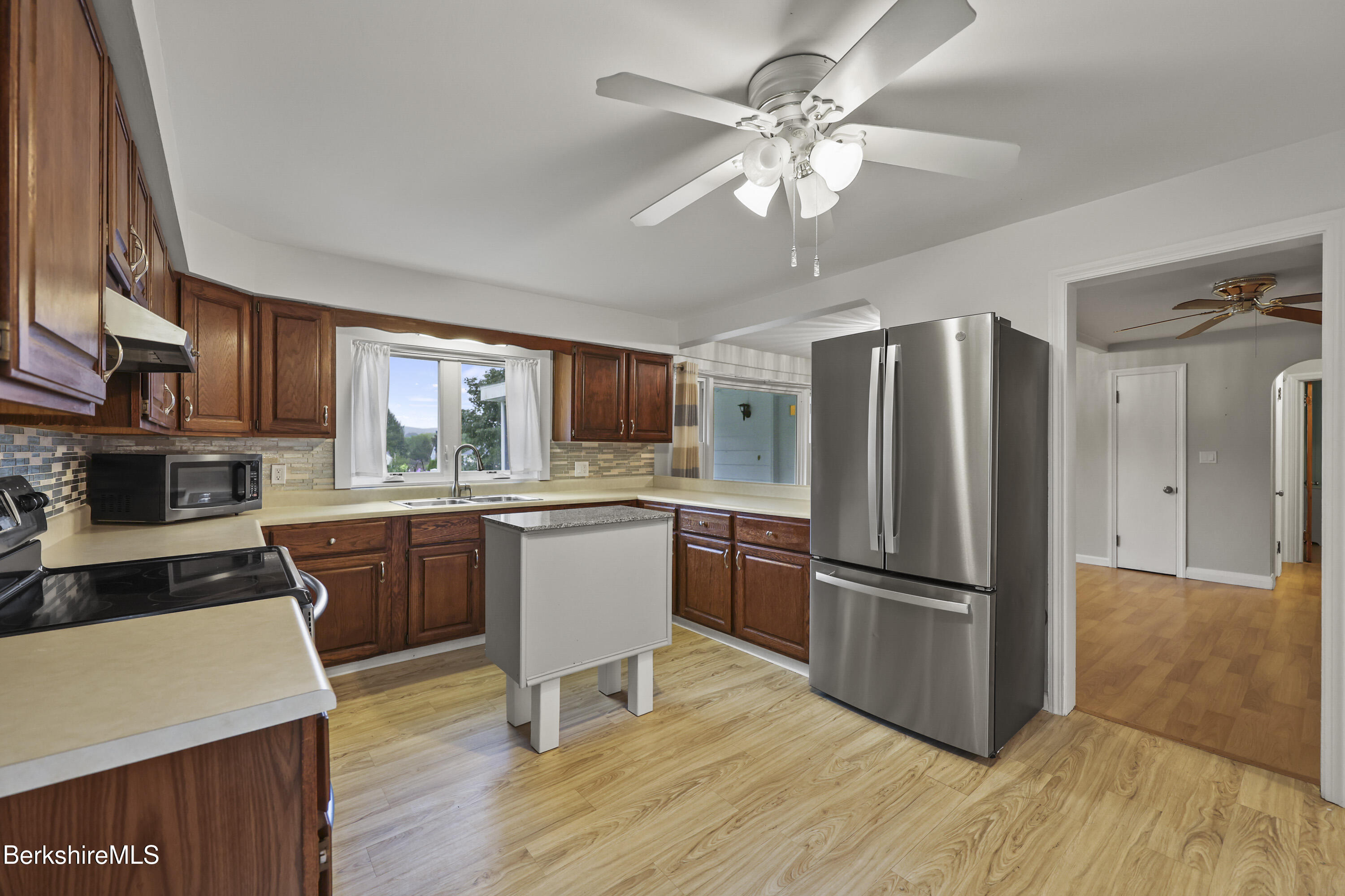 41 Deming Street Dalton, MA 01226 - Photo 14 of 35 a kitchen with stainless steel appliances granite countertop a refrigerator a stove a sink dishwasher and a dining table with wooden floor
