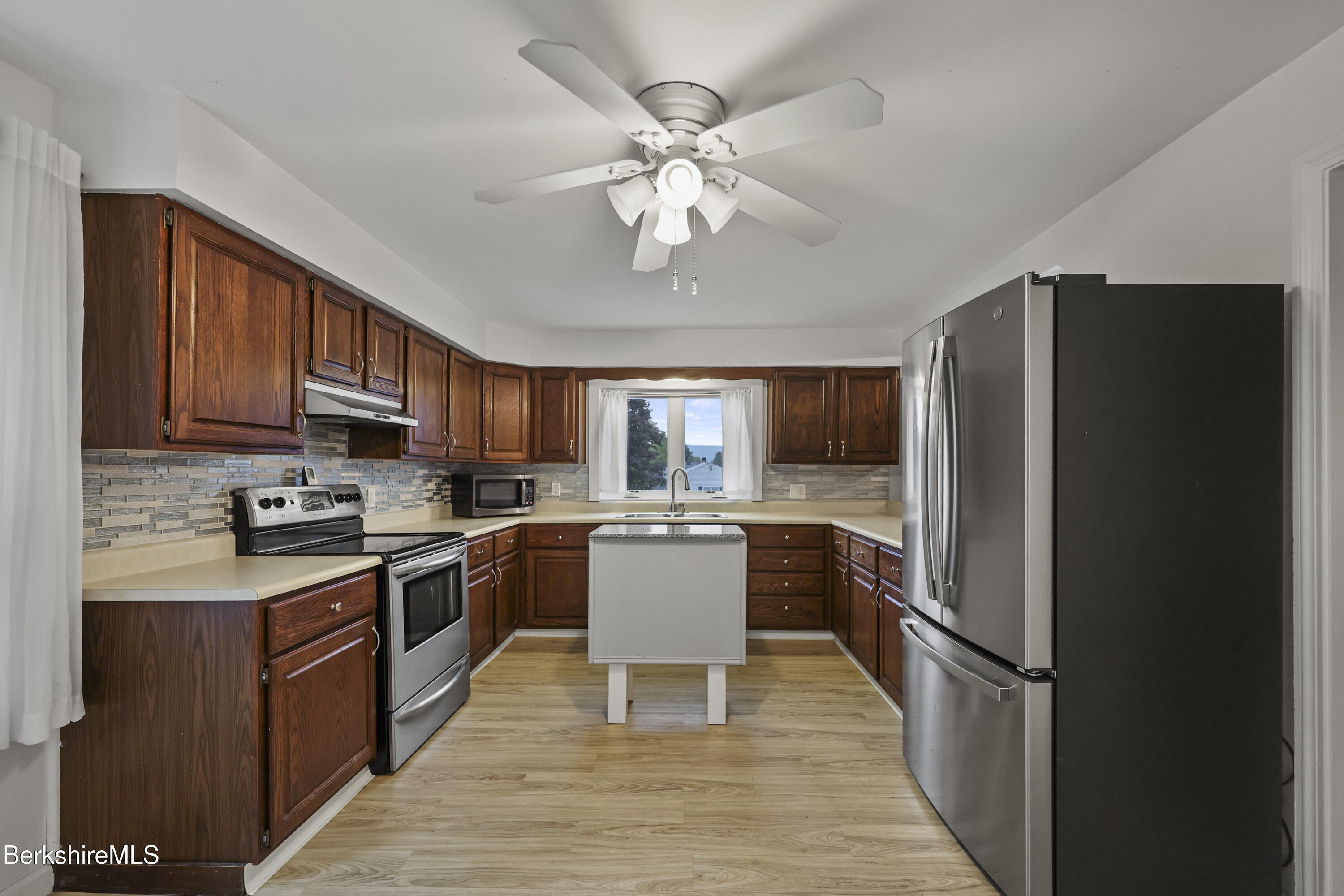 41 Deming Street Dalton, MA 01226 - Photo 17 of 35 a kitchen with a refrigerator and a stove top oven