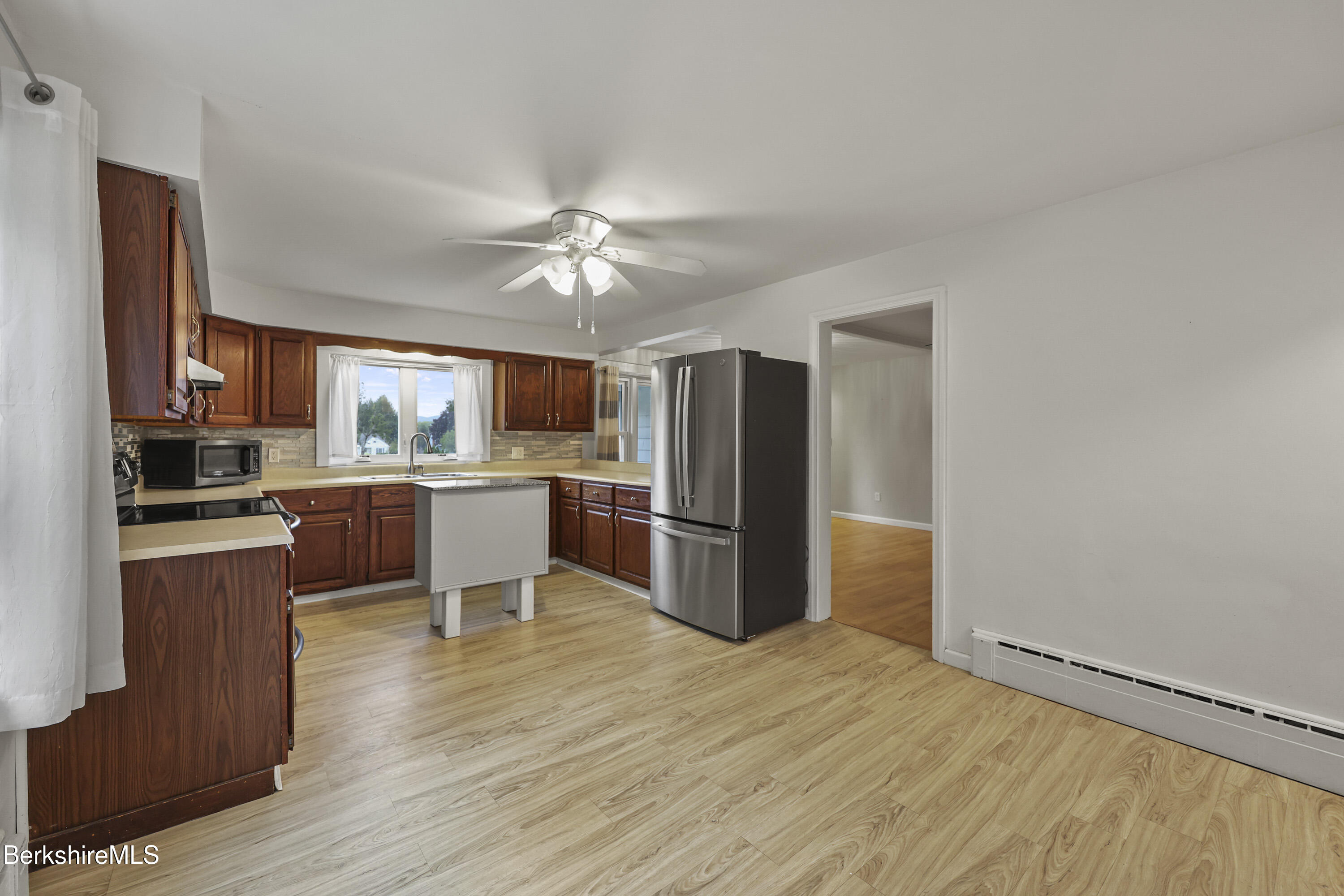 41 Deming Street Dalton, MA 01226 - Photo 18 of 35 a kitchen with stainless steel appliances granite countertop a refrigerator a sink dishwasher a stove with wooden cabinets and floor