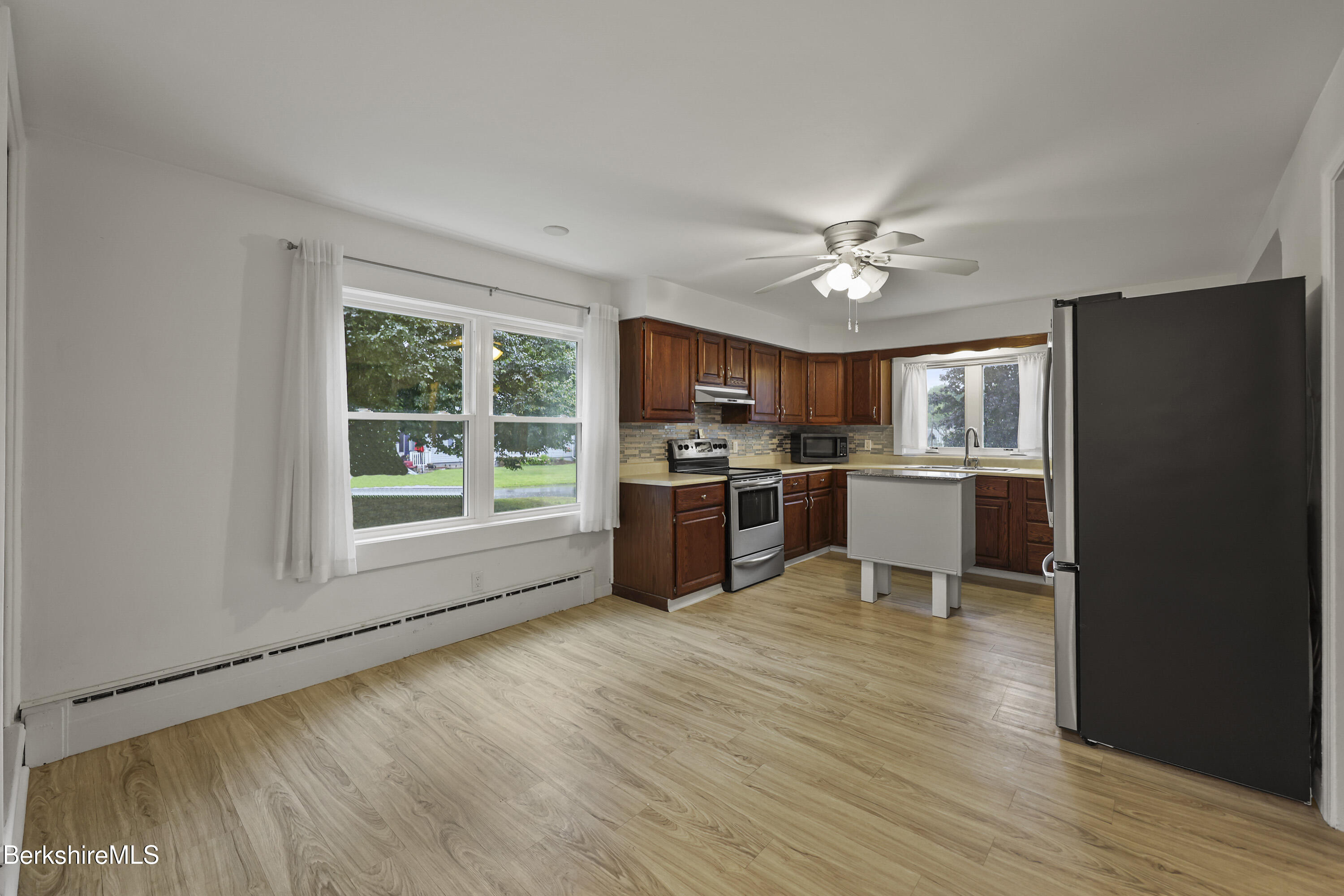41 Deming Street Dalton, MA 01226 - Photo 19 of 35 a kitchen with stainless steel appliances a stove a refrigerator and a microwave