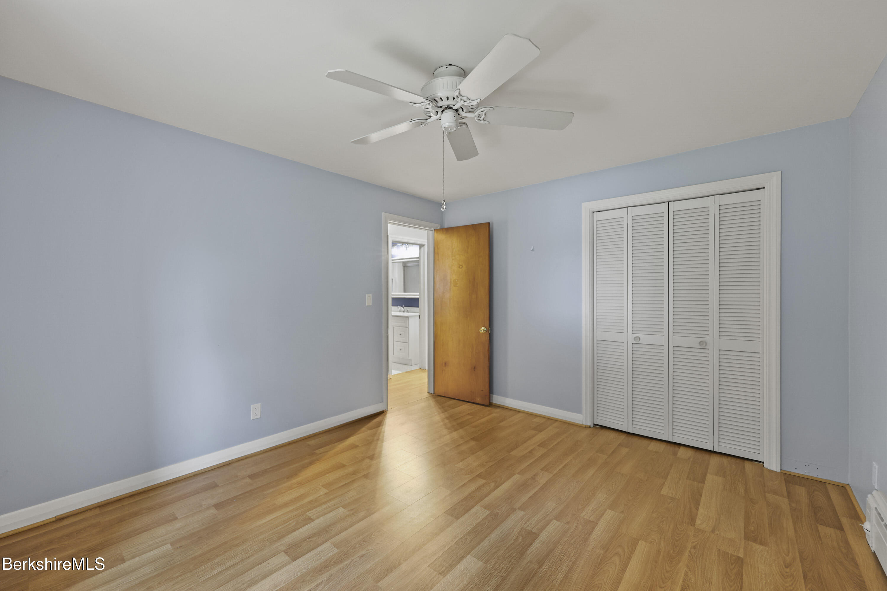 41 Deming Street Dalton, MA 01226 - Photo 22 of 35 a view of an empty room with wooden floor and a ceiling fan