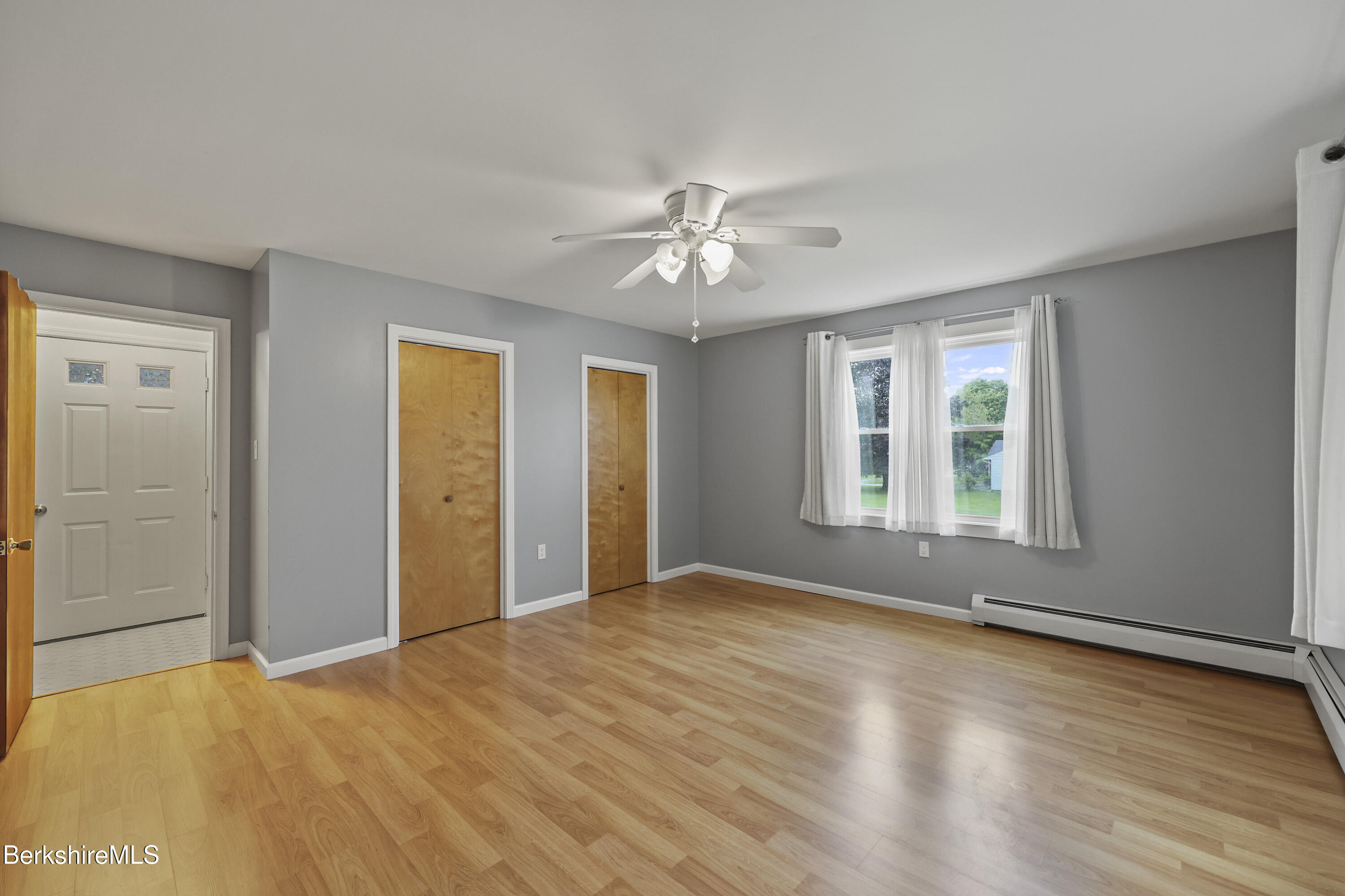41 Deming Street Dalton, MA 01226 - Photo 25 of 35 a view of empty room with wooden floor and fan