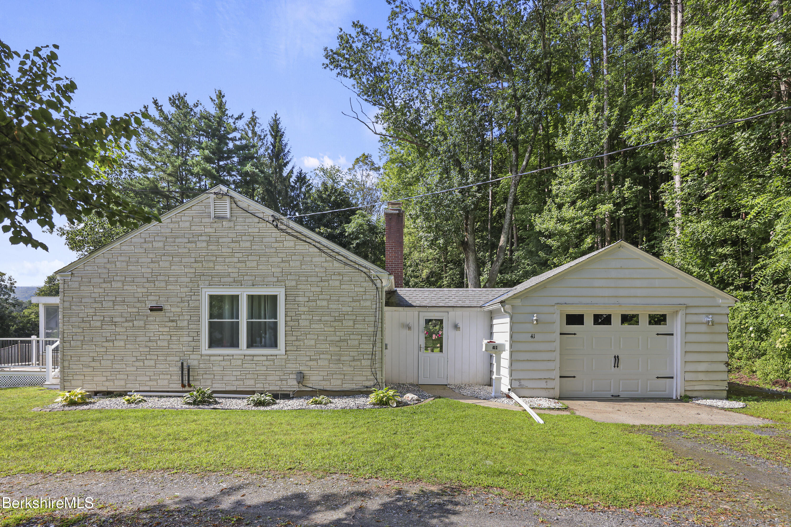41 Deming Street Dalton, MA 01226 - Photo 3 of 35 a front view of a house with a yard and garage