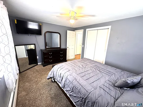 a bedroom with a bed and a chandelier
