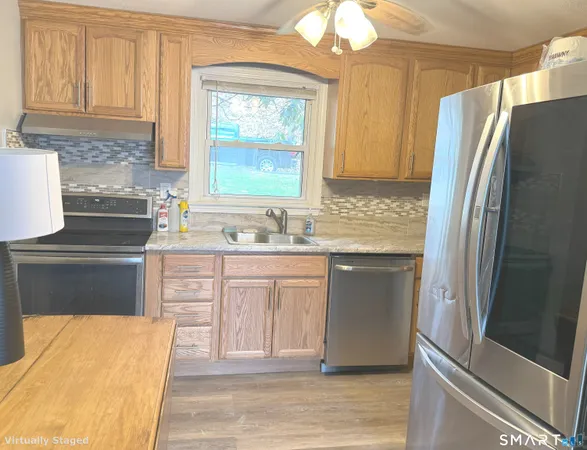 a kitchen with stainless steel appliances a refrigerator sink and cabinets