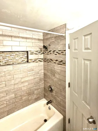 a bathroom with a bathtub and shower