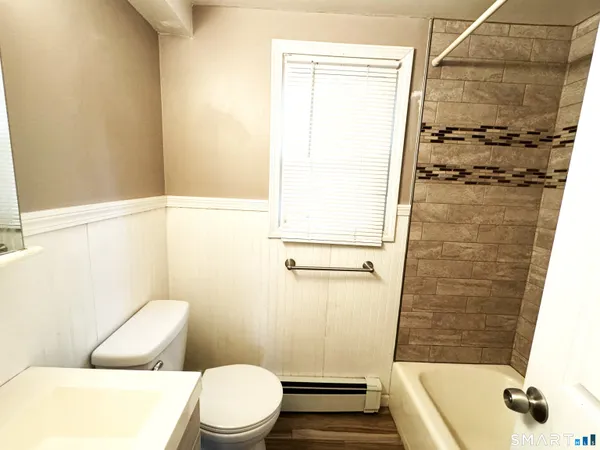 a bathroom with a shower and a toilet