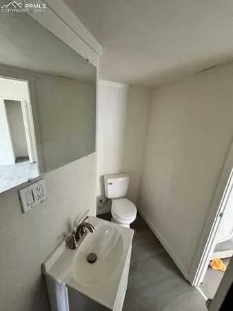 a bathroom with a sink a toilet and mirror