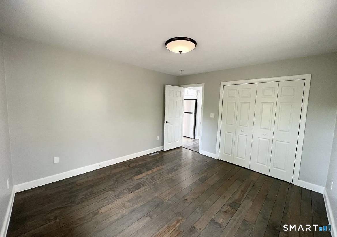 270 R East Street Plainville, CT 06062 - Photo 8 of 28 an empty room with wooden floor and windows