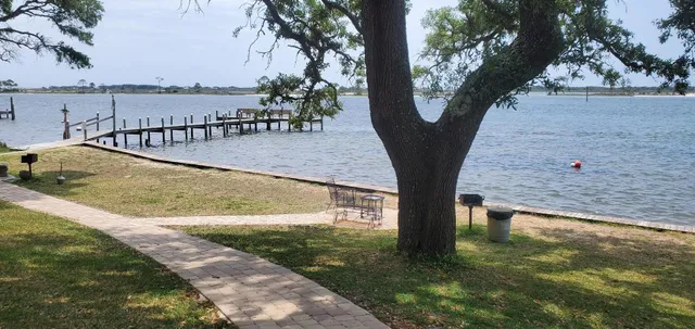a view of swimming pool with a yard and large trees