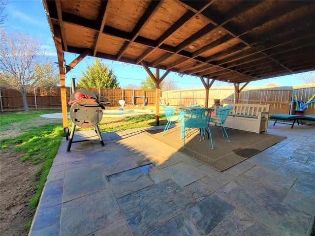 a view of a backyard with sitting area