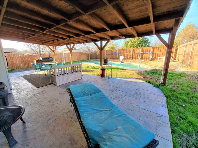 a view of a swimming pool with a yard