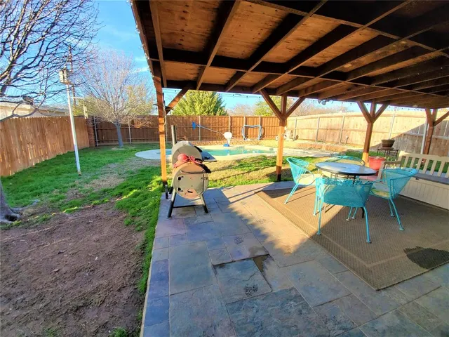 a view of yard with patio