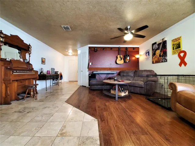 a living room with furniture and a piano