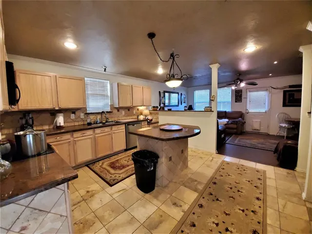 a kitchen with a sink appliances and cabinets