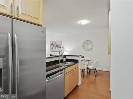 a kitchen with stainless steel appliances granite countertop a sink and cabinets