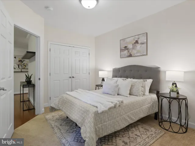 a bedroom with a bed and a lamp